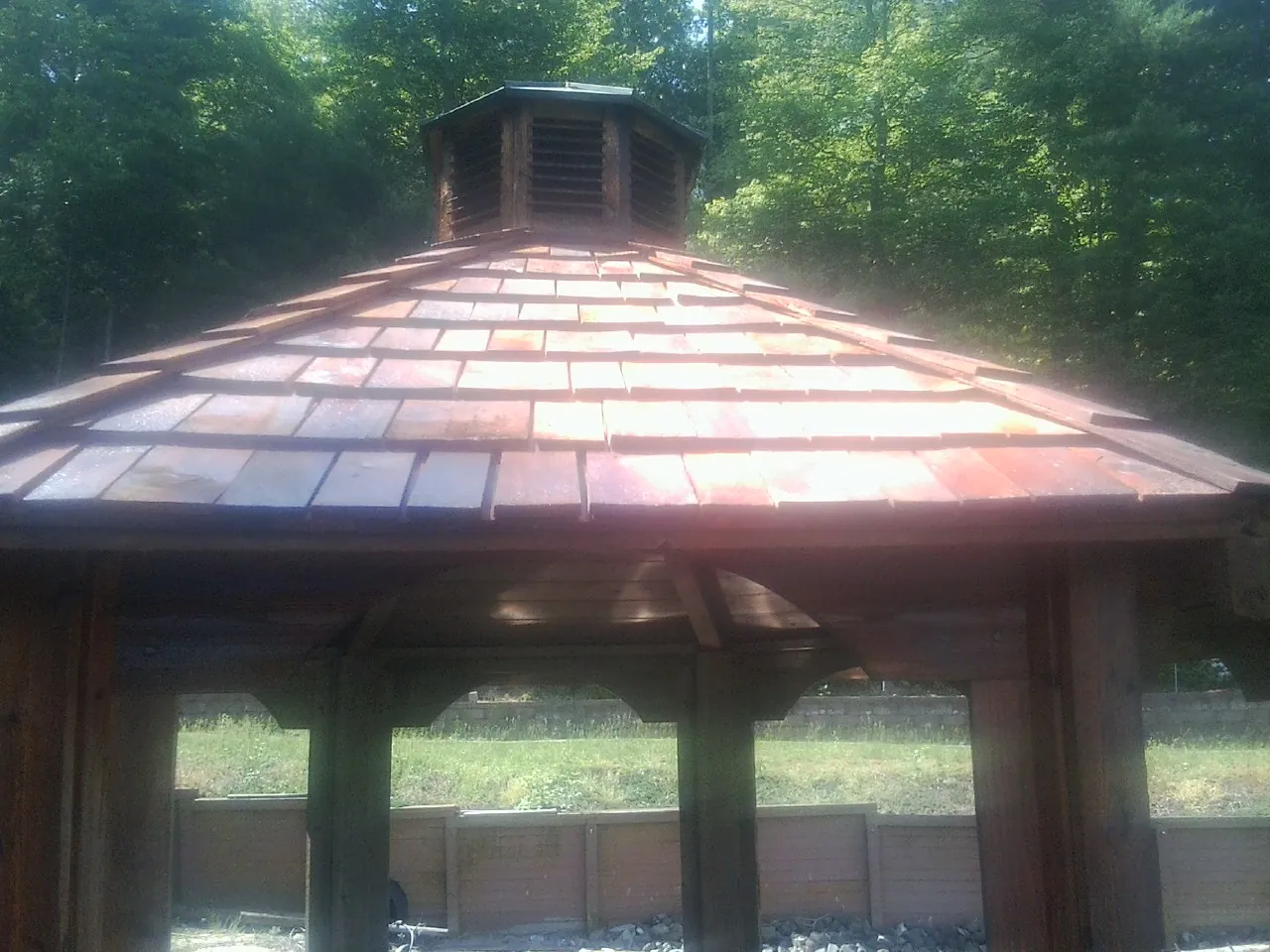New cedar shake roof and cupola on a lakeside gazebo in Ewell
